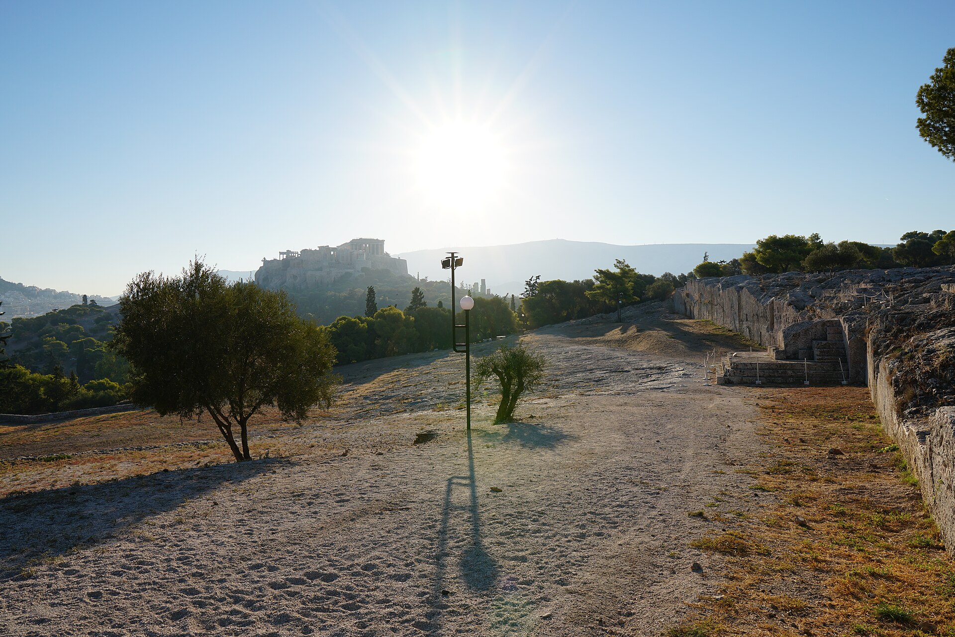 The Pnyx hill in Athens, looking toward the bema (speaker's platform) where Pericles, Demosthenes, and Aristides addressed the Athenian Assembly.